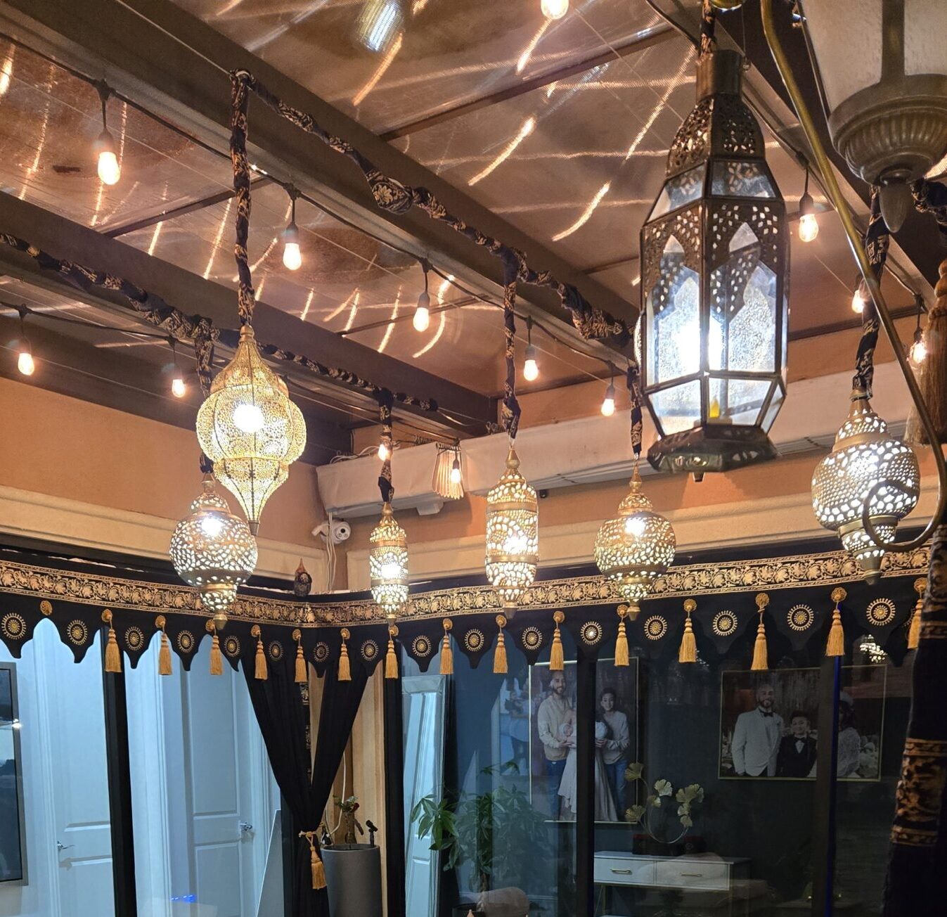 Ornate Moroccan lanterns creating warm, ambient lighting inside a tent—perfect for exotic film settings or night scenes