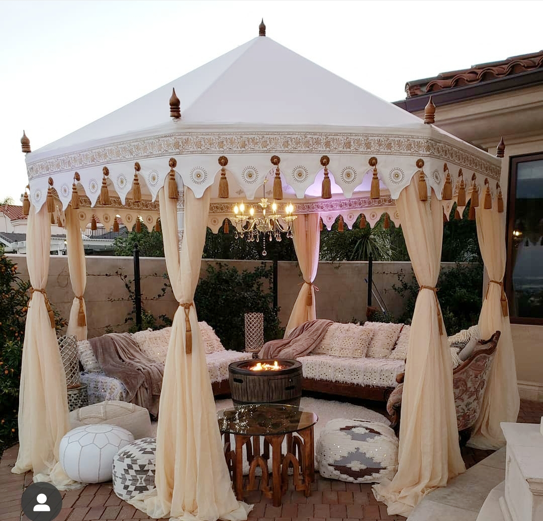 Whimsical bohemian tent with layered fabrics and eclectic decor, suitable for indie films or music videos with a boho-chic aesthetic